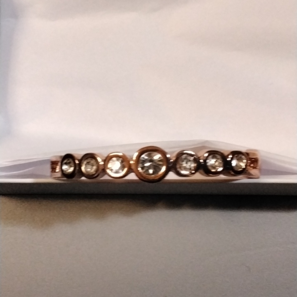 A copper bracelet with fake diamonds